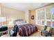 Comfortable bedroom with neutral tones, plantation shutters, and a cozy seating area at 4875 S Monaco St # 105, Denver, CO 80237