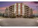 Elegant condo building featuring multiple balconies and a brick and beige facade at 4875 S Monaco St # 105, Denver, CO 80237