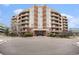 Well-maintained building exterior featuring brick accents, balconies, and landscaped surroundings at 4875 S Monaco St # 105, Denver, CO 80237