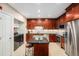 This gourmet kitchen boasts custom cabinetry, stainless steel appliances, and a center island at 4875 S Monaco St # 105, Denver, CO 80237