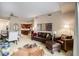 Open-concept living room, connected to the dining area and kitchen, features a comfortable seating area at 4875 S Monaco St # 105, Denver, CO 80237