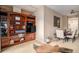 Cozy living room showcases custom built-in shelving and flows into the dining area at 4875 S Monaco St # 105, Denver, CO 80237