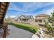 Expansive backyard showcasing artificial turf, a charming statue, and neighboring homes in a serene setting at 8099 Arapahoe Peak St, Littleton, CO 80125