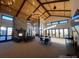 Relax and unwind in this inviting clubhouse with soaring ceilings, fireplace, and floor-to-ceiling windows at 8099 Arapahoe Peak St, Littleton, CO 80125