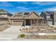 Charming single-Gathering home with a two-car garage, a covered porch, desert landscaping and solar panels at 8099 Arapahoe Peak St, Littleton, CO 80125