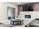 Basement fireplace with a modern electric insert and walk-out sliding doors at 8099 Arapahoe Peak St, Littleton, CO 80125