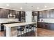 Spacious kitchen featuring dark cabinets, stainless appliances, and island at 8099 Arapahoe Peak St, Littleton, CO 80125