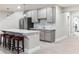 Basement kitchenette with stainless steel appliances, stylish gray cabinets, and granite countertops at 8099 Arapahoe Peak St, Littleton, CO 80125