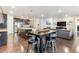 An open living space showcases a modern kitchen, dining table, and comfortable living room area at 8099 Arapahoe Peak St, Littleton, CO 80125