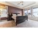 Relaxing main bedroom with a ceiling fan, many large windows and a king-size sleigh bed at 8099 Arapahoe Peak St, Littleton, CO 80125