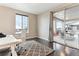 Bright office features a large window for natural light and a sliding glass door leading to an outdoor deck at 8099 Arapahoe Peak St, Littleton, CO 80125