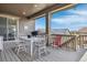 Spacious back deck with an outdoor dining area, seating and views at 8099 Arapahoe Peak St, Littleton, CO 80125