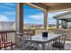 Covered back deck featuring beautiful views, dining table and chairs at 8099 Arapahoe Peak St, Littleton, CO 80125
