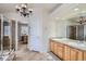 Bathroom with double sinks, shower stall and an adjoining room visible through the doorway at 10551 Redcone Way, Highlands Ranch, CO 80130