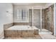 Bathroom featuring tile flooring, separate shower and soaking tub at 10551 Redcone Way, Highlands Ranch, CO 80130