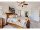 Bedroom with ceiling fan, floral bedding and picture window at 10551 Redcone Way, Highlands Ranch, CO 80130