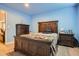 Bright bedroom with a wooden bed frame, colorful blanket, and side tables, creating a cozy and inviting retreat at 10551 Redcone Way, Highlands Ranch, CO 80130