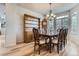 Elegant dining room with hardwood floors, a large wooden table, and a classic chandelier at 10551 Redcone Way, Highlands Ranch, CO 80130