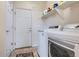 Well-lit laundry room with appliances, shelving, and storage space at 10551 Redcone Way, Highlands Ranch, CO 80130