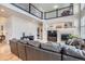 Cozy living room with hardwood floors, fireplace, and a view of the upper-level balcony at 10551 Redcone Way, Highlands Ranch, CO 80130