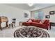 Cozy living room with a comfortable couch, decorative rug, and ample natural light for a welcoming ambiance at 10551 Redcone Way, Highlands Ranch, CO 80130