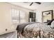 Well-lit bedroom with a ceiling fan, large window, mirrored closet doors, and comfortable furniture at 2650 Perry St, Denver, CO 80212