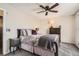 Cozy bedroom featuring a ceiling fan, large bed with decorative pillows, and a dresser at 2650 Perry St, Denver, CO 80212