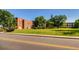 Brick building with large lawn, mature trees and a road in front at 2650 Perry St, Denver, CO 80212