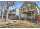 View of a house showing its front yard with mature trees and a neatly maintained lawn at 2650 Perry St, Denver, CO 80212