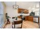 Well-lit kitchen with stainless appliances, wood cabinets, granite countertops, and a glass table with seating at 2650 Perry St, Denver, CO 80212