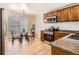 Charming kitchen with stainless steel appliances, granite countertops, and a glass table with seating by the window at 2650 Perry St, Denver, CO 80212