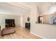 Open-concept floor plan with living room flowing into the kitchen with a bar-top counter and hardwood floors at 2650 Perry St, Denver, CO 80212