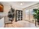 Bright room with a shelving unit, lots of plants, and a glass door leading to the outside at 2650 Perry St, Denver, CO 80212