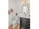 Modern powder room with dark vanity, gold fixtures, and stylish decor at 2521 Champa St, Denver, CO 80205