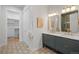 Modern bathroom with a double vanity, patterned tile floor, and walk-in shower at 2521 Champa St, Denver, CO 80205