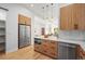 Modern kitchen with light wood cabinets, quartz countertops, and stainless steel appliances at 2521 Champa St, Denver, CO 80205