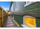 Side yard with stone path and basement window at 2521 Champa St, Denver, CO 80205