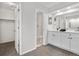 A bathroom with double vanity, bright lighting, and a doorway to the toilet and shower at 12662 E Warren Dr # F, Aurora, CO 80014