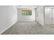 A bright, carpeted bedroom with a window and door letting in natural light at 12662 E Warren Dr # F, Aurora, CO 80014