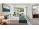 Bright bedroom with stylish decor, large window, and comfortable seating area at 12662 E Warren Dr # F, Aurora, CO 80014
