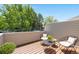 Relax on this deck with chairs and views of the surrounding trees and backyard at 12662 E Warren Dr # F, Aurora, CO 80014
