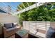 Outdoor patio with comfortable seating and a pergola, surrounded by lush greenery at 12662 E Warren Dr # F, Aurora, CO 80014