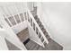 Bright staircase with white railings and neutral-toned carpet, connecting multiple levels in the home at 12662 E Warren Dr # F, Aurora, CO 80014