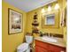 Stylish bathroom with a decorative mirror, unique towel rack, and warm-toned vanity at 8166 E Phillips Ave, Centennial, CO 80112