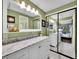 Stylish bathroom with white double sink vanity, marble countertop and modern sliding mirror doors at 8166 E Phillips Ave, Centennial, CO 80112