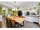 Inviting dining room with hardwood floors and view into kitchen with stainless steel appliances and island at 8166 E Phillips Ave, Centennial, CO 80112