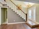 Bright entryway featuring a staircase with white risers, hardwood floors, and a glass-paneled front door at 8166 E Phillips Ave, Centennial, CO 80112