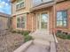 Beautifully maintained brick facade with trimmed landscape, with a glass-paneled entry door at 8166 E Phillips Ave, Centennial, CO 80112