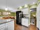 Eat-in kitchen with modern stainless steel fridge and access to sitting room at 8166 E Phillips Ave, Centennial, CO 80112