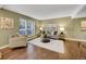 Comfortable living room featuring a large window, plush seating, and hardwood floors with a stylish rug at 8166 E Phillips Ave, Centennial, CO 80112